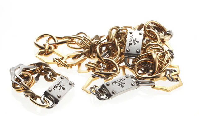 シェイプの異なる大振りなモチーフをつなぎ合わせたチェーンネックレスとチェーンブレスレットは、バックルのブランドロゴもアクセントに。ブレスレット 5万9850円、ロングネックレス 11万4450円、ネックレス 9万9750円（すべてプラダ／プラダ ジャパンカスタマーリレーションズ｜0120-559-914）