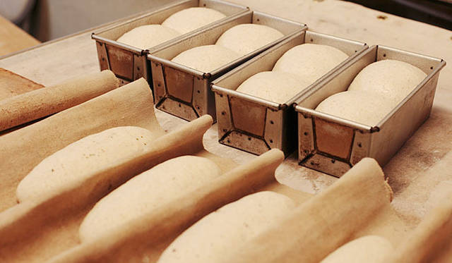 スピカ・麦の穂｜オーブンの前で待機中のパン。『スピカ・麦の穂』のパンは天然酵母パンの特長として、焼き上がってから2日目、3日目と日が経つと、酵母の風味が増し、素材の味も馴染んでより味わい深くなる