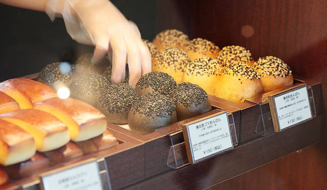 <b>Boulangerie Sudo｜ブーランジェリー スドウ</b>　大人気の「薄皮黒ゴマあんぱん」。店内の小さなイートインコーナーでは、飲物と一緒に焼きたてパンをいただくことができる。