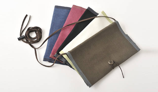 <strong>植木明日子｜『BookPacker』 ／phrungnii(プルンニー)</strong>　ガイドブックや文庫本をかばんから出し入れすることなく、肩から下げて持ち歩くことができるブックカバー。 