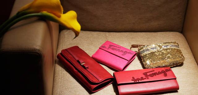 <strong>Salvatore Ferragamo｜サルヴァトーレ フェラガモ</strong> ホリデーのギフトにかぎらずとも、いつもらってもうれしい財布やポーチなど、鞄のなかの必需品たち。アクセサリーをまとめて入れられるビジューケースは、日常でも旅先でもとても便利なアイテム。ロゴをラインストーンであしらっていたり、スパンコールや“ヴァラ”リボンのモチーフが、さりげなく可愛らしさを演出してくれる。そう、大人の女性だからこそ、あえてガーリッシュかつエレガントなモチーフを好むものらしい。フェラガモのアイコン“ヴァラ”リボンを配したビジューポーチ（W23×H10） 三つ折り3コンパートメントで、ネックレス、リング、ピアスの収納が可能 4万6200円。ラインストーンでブランドロゴをあしらった二つ折り財布（W12×H11cm） 4万6200円。長財布（W19×H10） 5万4600円。“ヴァラ”リボンをデザインしたスパンコールのポーチ（W15×D3×H10cm） 3万3600円。