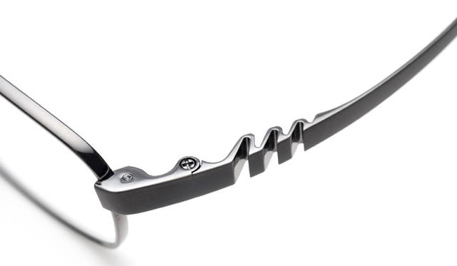 <strong>999.9｜フォーナインズ</strong>　S-84T col.12。テンプルデザイン：テンプルは、弾性の高い素材に負荷を吸収する形状を複数重ねて組み込んだ、蛇腹形状。テンプルにかかる負荷を解消し、掛け心地の良さとフレームの安定感を生む。テンプルデザインは、角度によって表情を変え、大人の男性の雰囲気をさらに引き立てる。