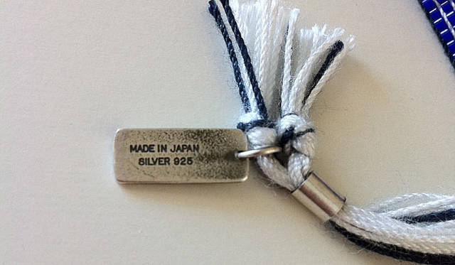 <strong>OUTDOOR PRODUCTS｜アウトドアプロダクツ</strong>　100本限定チャリティブレスレット　MADE IN JAPANと刻印されたシルバープレート