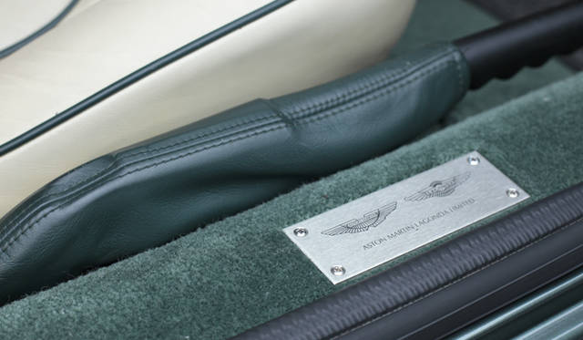 <strong>あなたのクルマ 見せてください　第1回｜田中知之（FPM）×アストンマーティンDB7</strong>　アストンマーティン・ラゴンダ社のプレートが光る。サイドブレーキは足元右側に配置。