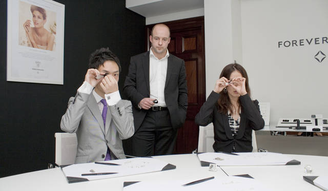 <strong>FOREVERMARK｜フォーエバーマーク</strong>　原石の選別作業を体験中の山田ご夫妻。ルーペを覗く目は真剣そのもの