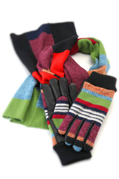 今季のブランドテーマである「遊牧民の民族衣装とスポーツウェアの融合」をニット製品で表したマフラー&グローブ。大胆な配色、ランダムな太さの縞模様が非常に躍動感を感じさせる仕上りだ。シンプルな装いも、これを一点取り入れるだけで個性的なコーディネイトに早変わり。グローブはしなやかなシープレザーとのコンビ。<br /><br />マフラー1万8375円、ニットグローブ1万5750円（以上Y-３）<br />　アディダス ファッション グループ ショールーム<br />Tel.03-5547-6501<br />
