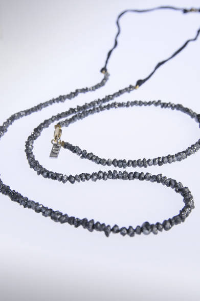 永遠の輝きを持つ貴石として憧れの存在であるダイヤモンド。ただし男性が身に着けるものとしてはやや華美な印象も。このラフカットのダイヤモンドをあしらったアクセサリーは、マニッシュな逞しさを感じさせる素朴なルックス。ゆえに最高級の貴石でありながら、ざっくばらんなニットスタイルにも合わせられる、優しい寛ぎ感を備えているのがポイント。これなら照れずに男性も身に着けられる。<br /> <br />ネックレス10万5000円、ブレスレット7万3500円（ユビー）<br />バーニーズ ニューヨーク銀座店<br />Tel.03-3289-1200