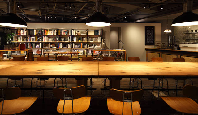 無機質なスケルトンにコントラストを与える暖かな木製家具