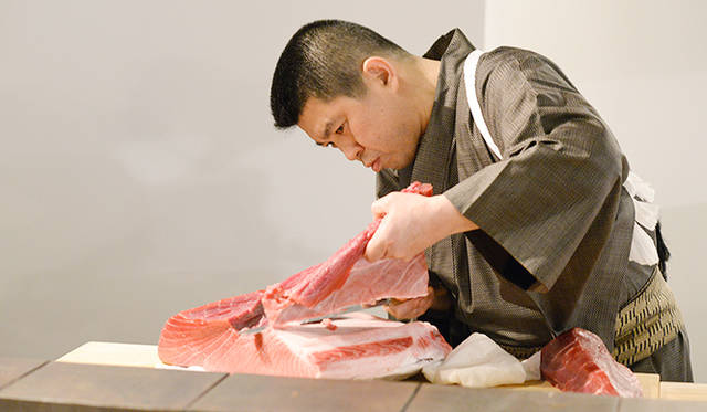 「鮨処多田」の多田氏は、ゲストの目の前でマグロをさばいてみせた。「鮨の花形はマグロ。特にこだわり、築地で一番のマグロを取り寄せ、にぎり以外にも大阪らしさを感じてもらえるように、押し寿司などもメニューにくわえました」