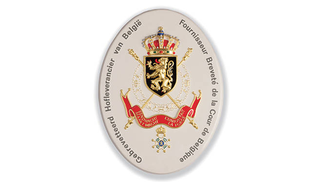 ベルギー王室御用達の紋章。デルヴォーは1883年、はじめてその名誉に浴した