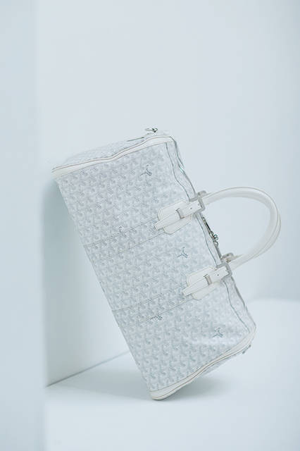 街からリゾートシーンにまで映えるボストンは、ホワイトをベースにしたキャンバス地にグレーの杉綾模様をあしらったさわやかな色合い。清涼感のある存在だけに、コーディネートの差し色としても活躍するはず。ライニングは鮮やかなイエローが採用されているのもお洒落。<br><br>バッグ[W45×H22×D22cm]489,240円／ゴヤール〈阪急うめだ本店2階〉〈阪急メンズ東京1階〉