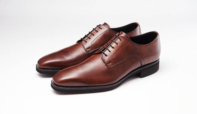 足幅が狭い若い世代に向け、ロングノーズ＆シングルEのシャープな木型を採用したシリーズ。深みとムラを湛えたブラウンのプレーントゥは品良く個性を表現できる。0万0000円