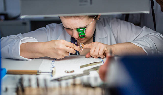ランゲの工房で部品の面取り加工を行う女性の時計師さん。女性の活躍が目立ちます。