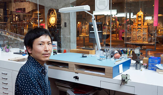 金澤真樹氏（1981年生まれ)。1999年渡仏。2001年にスイスに移り、 ル・ロックルの時計学校で時計師の資格をとったのち、時計修復科、複雑時計科を終了。 2010年、ジュリアス・ベア賞受賞。ヴィンセント・ベラール、カリ・ヴティラインネンの工房を経て、2013年ラ・ショー・ド・フォン国際時計博物館の時計修復師に着任。