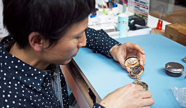 金澤真樹氏（1981年生まれ)。1999年渡仏。2001年にスイスに移り、 ル・ロックルの時計学校で時計師の資格をとったのち、時計修復科、複雑時計科を終了。 2010年、ジュリアス・ベア賞受賞。ヴィンセント・ベラール、カリ・ヴティラインネンの工房を経て、2013年ラ・ショー・ド・フォン国際時計博物館の時計修復師に着任。