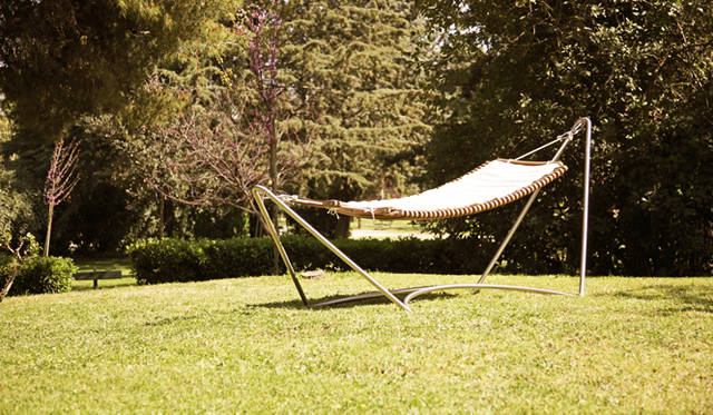 <strong>LIVING MOTIF｜リビング・モティーフ</strong><br />「OUTDOOR COOKING（アウトドアクッキング）」<br/>マホガニーを使用したハンモックのようなラウンジャーで、極上のリラックスタイムを。「Lounger」71万2800円